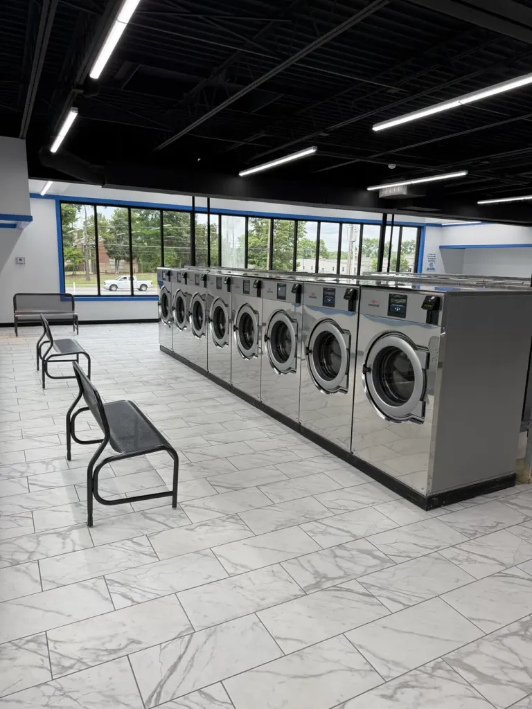 Mirror-finish Wascomat washer line inside the new Best Wash Laundromats store in Memphis