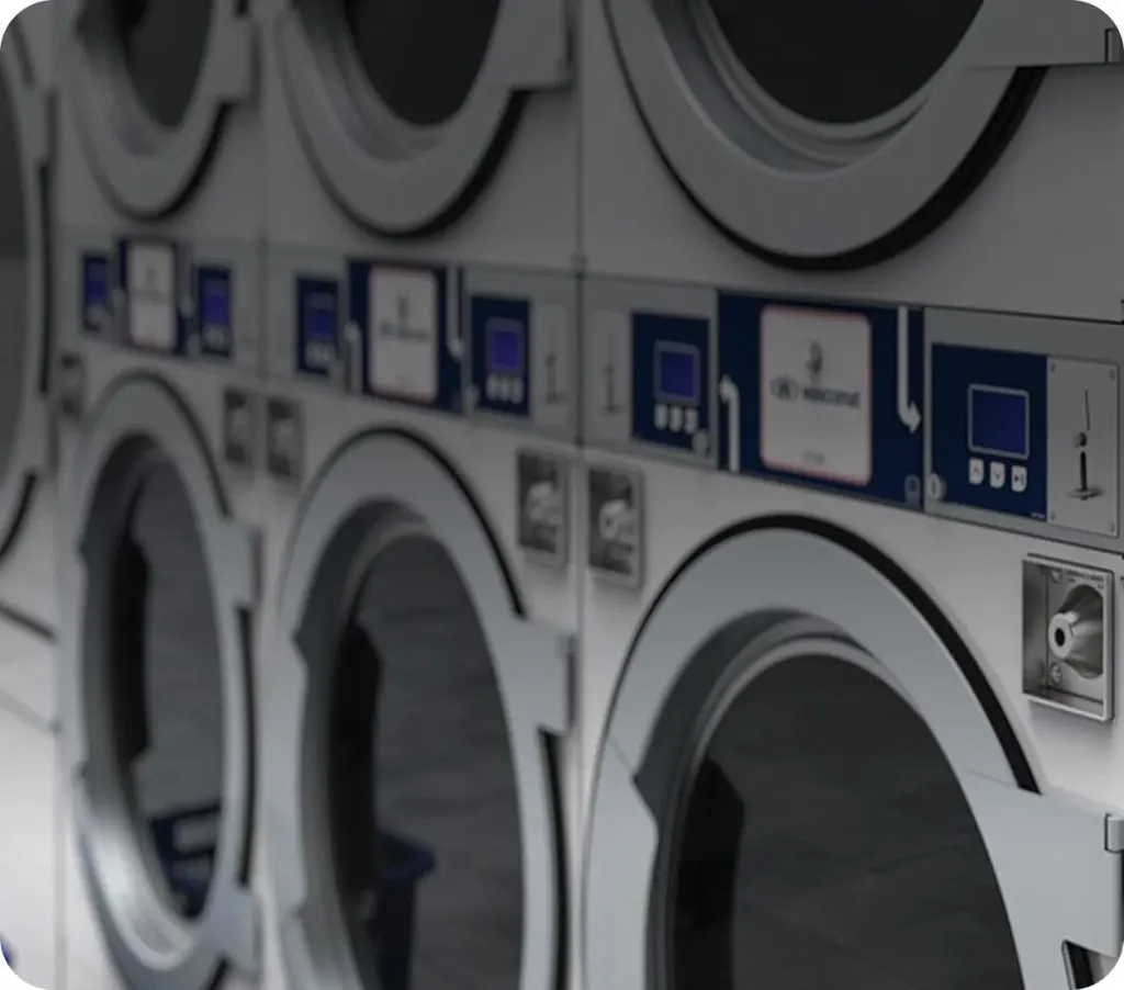 Self-service laundromat interior with seating and Wascomat equipment